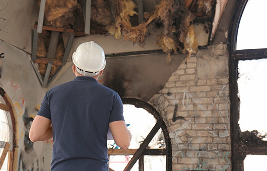 Independent Adjuster surveying a burned down building