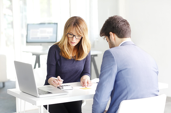 Insurance broker reviewing a claim with a client